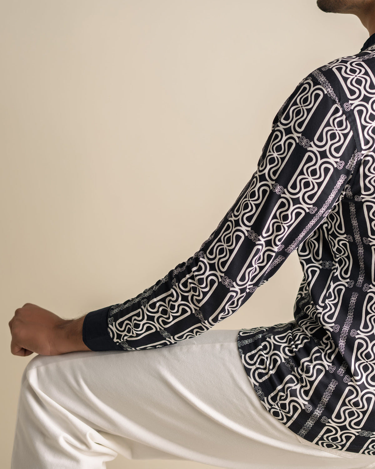 Sleeve and back view of the Mousson Shirt showing RUENCE monogram rain pattern.