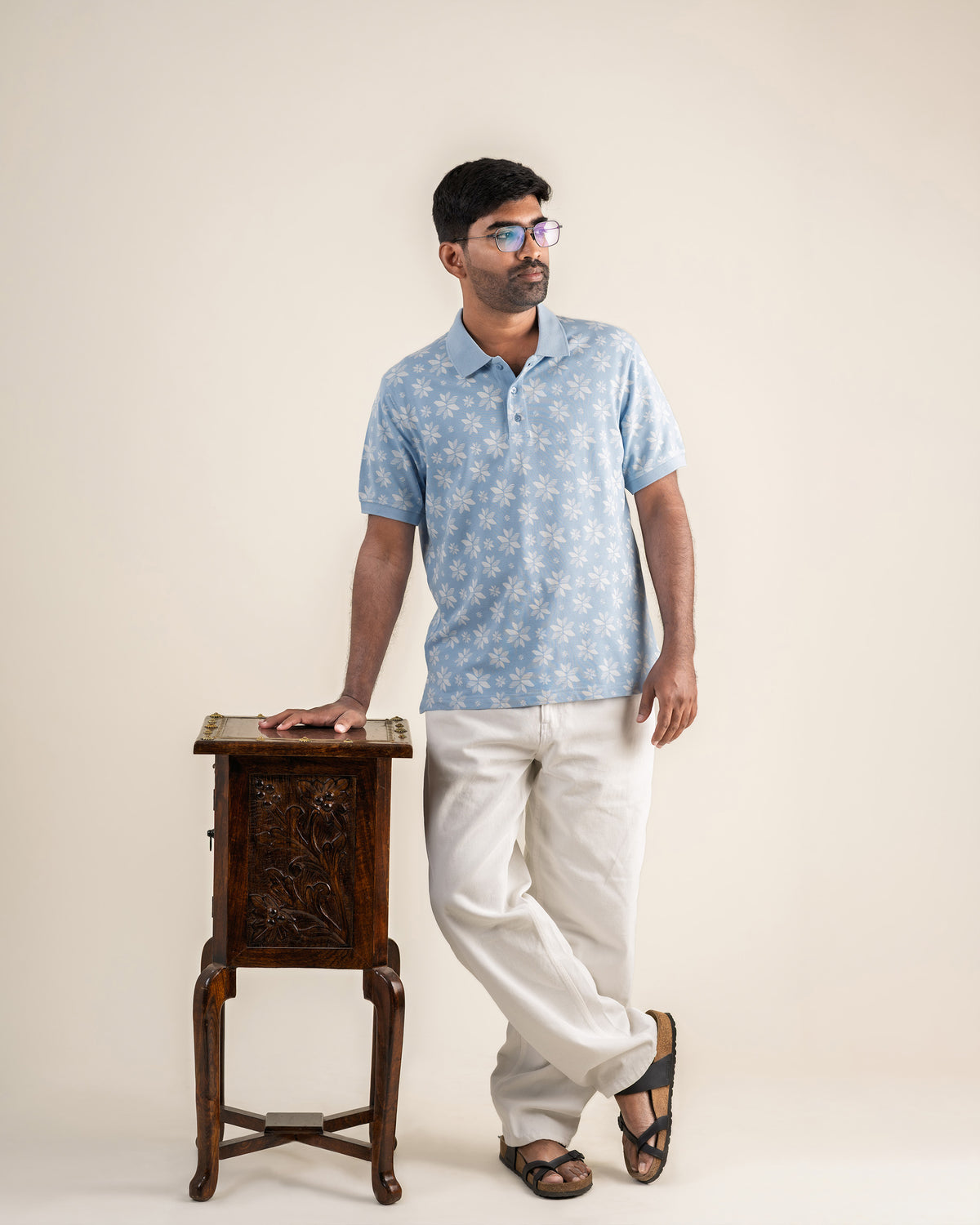 The Vela Polo by RUENCE in Cerulean with the cream fish tail print, front view.